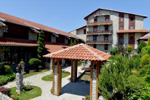 a garden with a gazebo in front of a building at Hotel Centar Balasevic in Belgrade