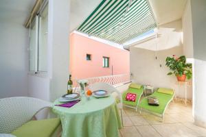 a balcony with a table and chairs with a bottle of wine at Villa Palma Apartments in Makarska