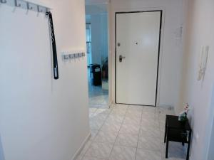 a hallway with a white door and a tile floor at Apartment by the beach with amazing sea view in Perea +134 photos