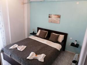 a bedroom with a bed with two towels on it at Apartment by the beach with amazing sea view in Perea