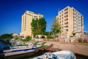 a couple of boats docked in a marina with buildings at Perla Royal Hotel - All Inclusive in Primorsko
