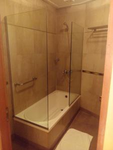 a shower with a glass enclosure in a bathroom at Hotel Le Park in San Miguel de Tucumán