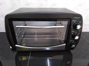 a black toaster oven sitting on a counter at Jerantut Homestay 2 in Jerantut +35 photos