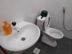 a bathroom with a white sink and a toilet at Jerantut Homestay 2 in Jerantut
