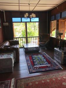 a living room with a couch and a table at Rumah Tiang 16 in Kampong Ulu Jepai