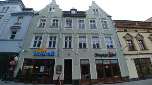 a large white building with a blue sign on it at Mostowa 3 in Bydgoszcz