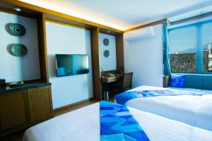 Postel nebo postele na pokoji v ubytování Lavana Hotel Chiangmai