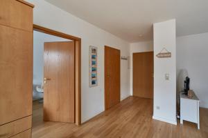 an empty room with a door and a hallway at Ferienwohnung Sonnendeck Moba-Travel in Priwall