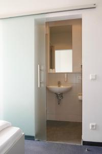
a bathroom with a sink and a mirror at Hotel zwischen den Seen in Waren
