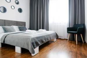 Posteľ alebo postele v izbe v ubytovaní Apartament Europejski