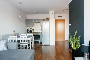 a kitchen and living room with a table and chairs at Apartament Europejski in Gorzów Wielkopolski