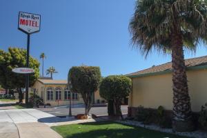 a motel sign in front of a building with palm trees at King's Rest Motel in Gilroy