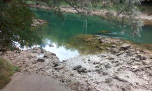 a pool of water with rocks in a river at Guest House Majstorovic in Banja Luka