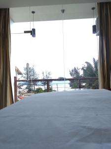 a bedroom with a bed with a view of the ocean at Bayfront in Weligama