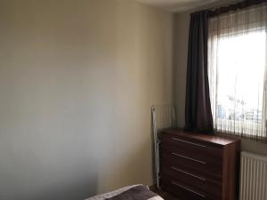 ザマールディにあるPanorama Sunshine Apartmanのベッドルーム1室(ベッド1台、窓、ドレッサー付)