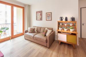 a living room with a couch and a window at Laguna Boutique Apartments in Mestre