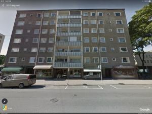 a large building with a car parked in front of it at Apartment in Turku center in Turku