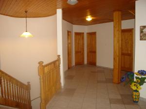 a hallway of a house with a staircase and wooden ceilings at Badacsony Apartmanház in Badacsonytomaj