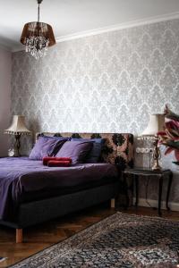 a bedroom with a purple bed and a wall at Posti Apartment in Haapsalu
