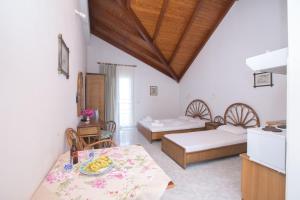 a room with two beds and a table with bananas on it at Marina Studios II in Argostoli