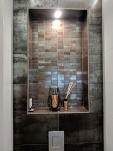 a bathroom with a shower with a tile wall at Amsterdam City Oasis in Amsterdam