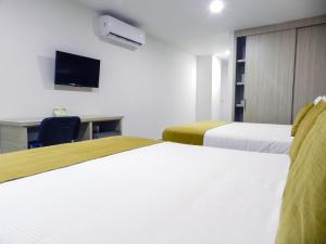 Łóżko lub łóżka w pokoju w obiekcie Hotel Tayrona del Mar