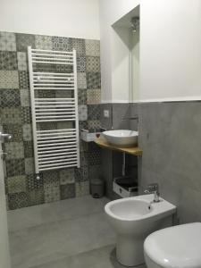 a bathroom with a white toilet and a sink at Sagittabondo in Campobasso