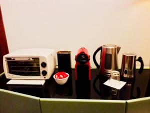 a counter with a toaster microwave and other kitchen items at B&B Mo Va Là in Budrio