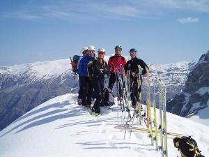a group of people standing on top of a snow covered mountain at Thalia Rooms in Kalabaka