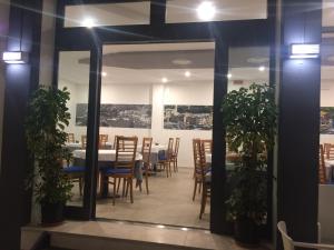 Hotel Portofino في كاورلي: غرفة طعام مع طاولة وكراسي ومرآة
