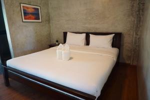 Postel nebo postele na pokoji v ubytování Baan Suan Ramita Resort