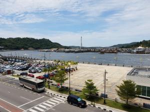 a parking lot next to a body of water at Qing yun resthouse Bandar, Brunei Darussalam in Bandar Seri Begawan