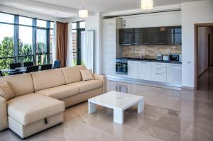 a living room with a couch and a table at Riviera Residence Apartments in Mamaia