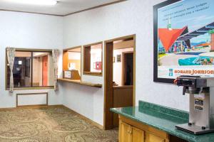 a waiting room with a large screen on the wall at Howard Johnson by Wyndham Wilmington in Wilmington