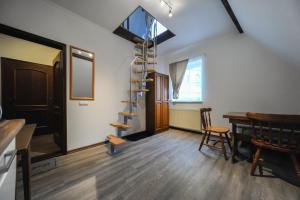 a room with a spiral staircase and a table and chairs at Old town center apartments on the Romantic Road in Harburg