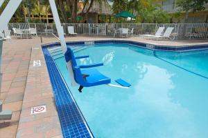 a blue surfboard in a pool of water at Ramada by Wyndham Fort Lauderdale Airport/Cruise Port in Fort Lauderdale