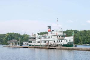 a large boat is docked at a dock at Howard Johnson by Wyndham Gravenhurst in Gravenhurst