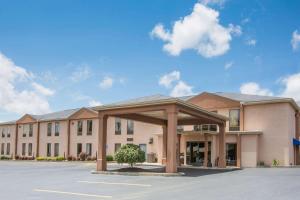 a large building with a parking lot in front of it at Howard Johnson by Wyndham Beckley in Beckley