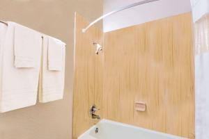 a bathroom with a shower, sink, and toilet at Howard Johnson by Wyndham Phoenix Airport/Downtown Area in Phoenix