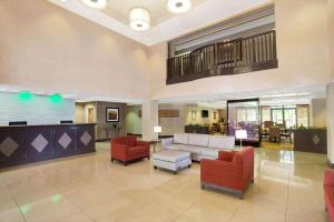 a lobby of a hospital with couches and chairs at Wingate by Wyndham Raleigh Durham / Airport in Durham