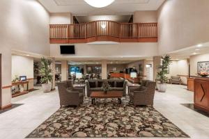 a lobby of a hospital with chairs and a table at Wingate by Wyndham - Edmonton West in Edmonton