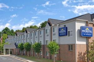 a rendering of the exterior of a hotel at Microtel Inn by Wyndham University Place in Charlotte