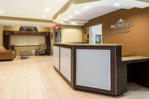 a lobby with a large counter in a hotel room at Microtel Inn and Suites North Canton in North Canton