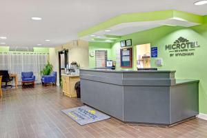 a lobby of a mro hospital with a counter at Microtel Inn & Suites by Wyndham Statesville in Statesville