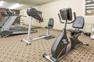 a gym with two tread machines and a tv at Microtel Inn & Suites by Wyndham Jacksonville Airport in Jacksonville