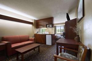 a living room with a couch and a kitchen at Microtel Inn & Suites by Wyndham Lithonia/Stone Mountain in Lithonia