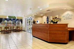 a lobby of a hospital with a counter and chairs at Microtel Inn & Suites by Wyndham Huntsville in Huntsville