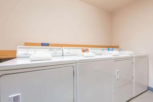 a row of washing machines in a room at Microtel Inn & Suites by Wyndham Altus in Altus