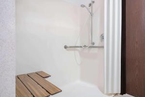 a shower in a bathroom with a shower curtain at Microtel Inn La Crosse Onalaska Area in Onalaska