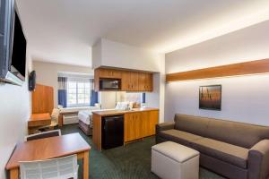 a hotel room with a couch and a bed at Microtel Inn & Suites by Wyndham Port Charlotte Punta Gorda in Port Charlotte